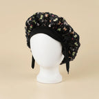 Bonnet en satin bébé motif floral, coloris noir