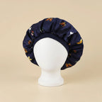 Bonnet en satin enfant motif floral, coloris bleu marine