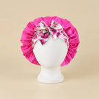 Bonnet en satin imprimé floral, coloris fuchsia