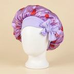 Bonnet en satin fille motif fruits à nœud, coloris violet